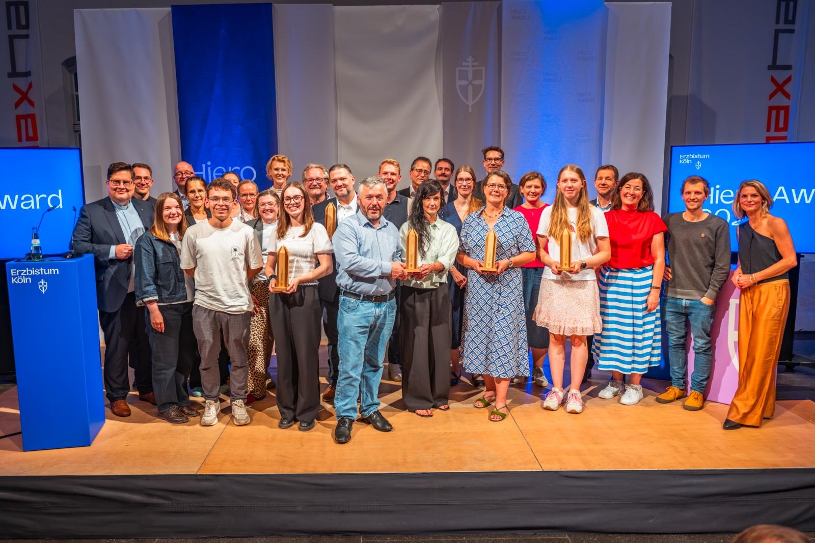 Hiero Award 2026 Preisverleihung zum Hiero Award 2026 am 30. September 2026 im Maxhaus in Düsseldorf, die Preisträgerinnen und Preisträger gemeinsam auf der Bühne mit der Jury, den Laudatoren, Generalvikar Tobias Hopmann, Amtsleiter Frank Hüppelshäuser und Moderatorin Anja Backhaus